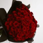 Classic Charm bouquet of red roses wrapped in black paper by DV Flowers