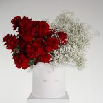 Modern Romance flower arrangement with red roses and white gypsophila in a modern white hat box
