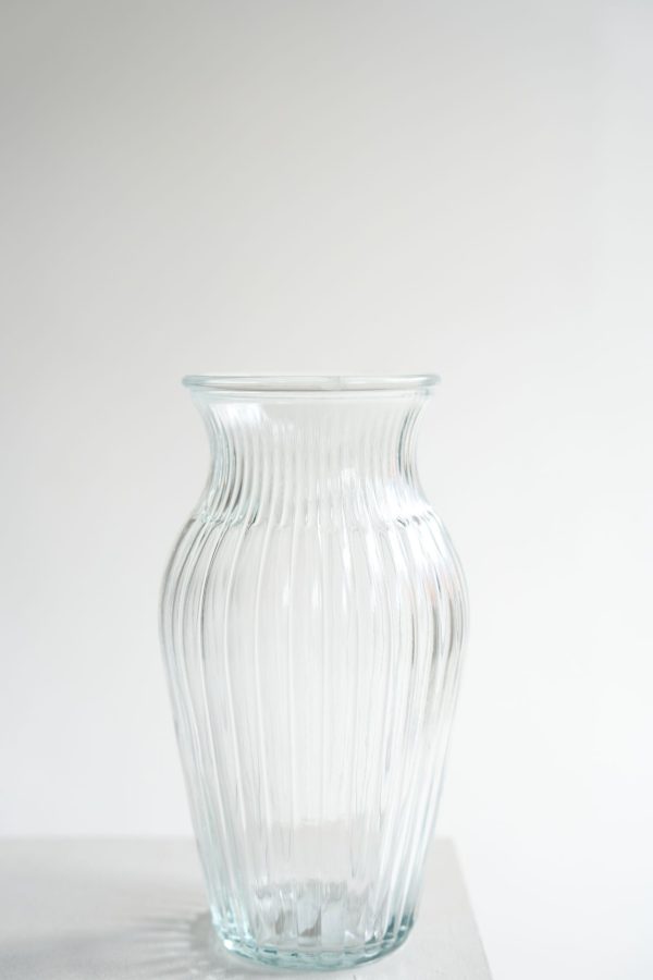 Classic Clear Glass Vase A clear ribbed glass vase, perfectly sized for hand-tied bouquets and seasonal arrangements. Height: 20 cm | Width: 12 cm