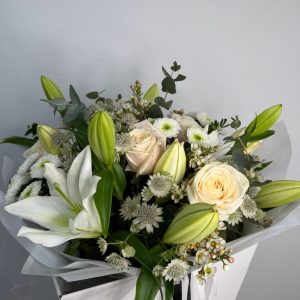 White Symphony bouquet with white lilies and ivory roses in DV Flowers gift bag