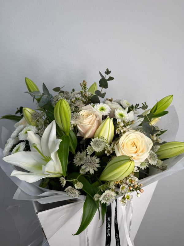 White Symphony bouquet with white lilies and ivory roses in DV Flowers gift bag