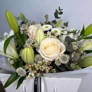 White Symphony bouquet with white lilies and ivory roses in DV Flowers gift bag