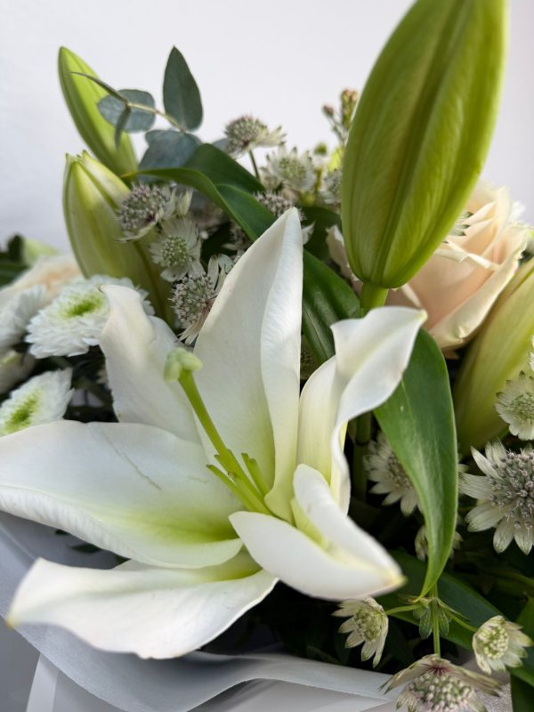 White Symphony bouquet with white lilies and ivory roses in DV Flowers gift bag